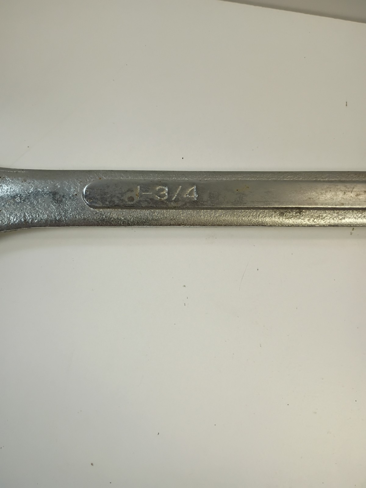 1 3/4-inch combination wrench featuring an open end and a 12-point box end