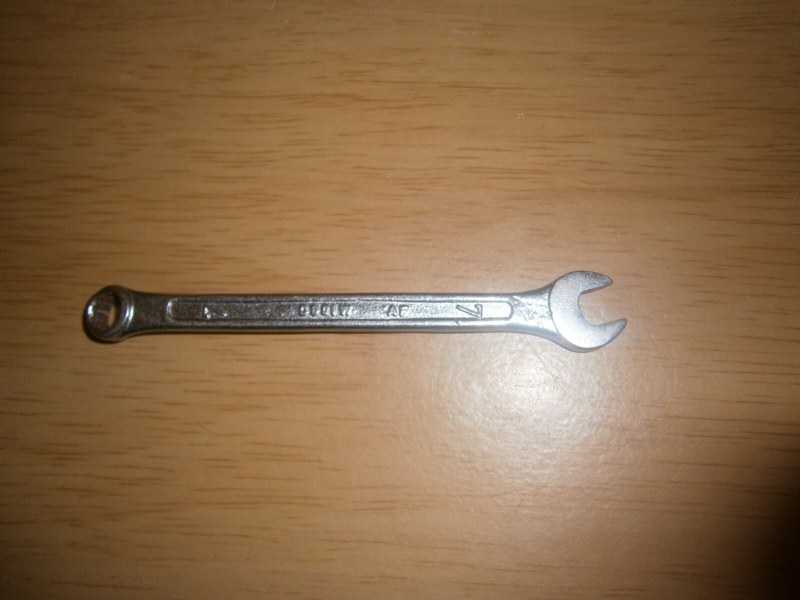 Vintage silver tone spanner. 7mm both ends.(E6c)