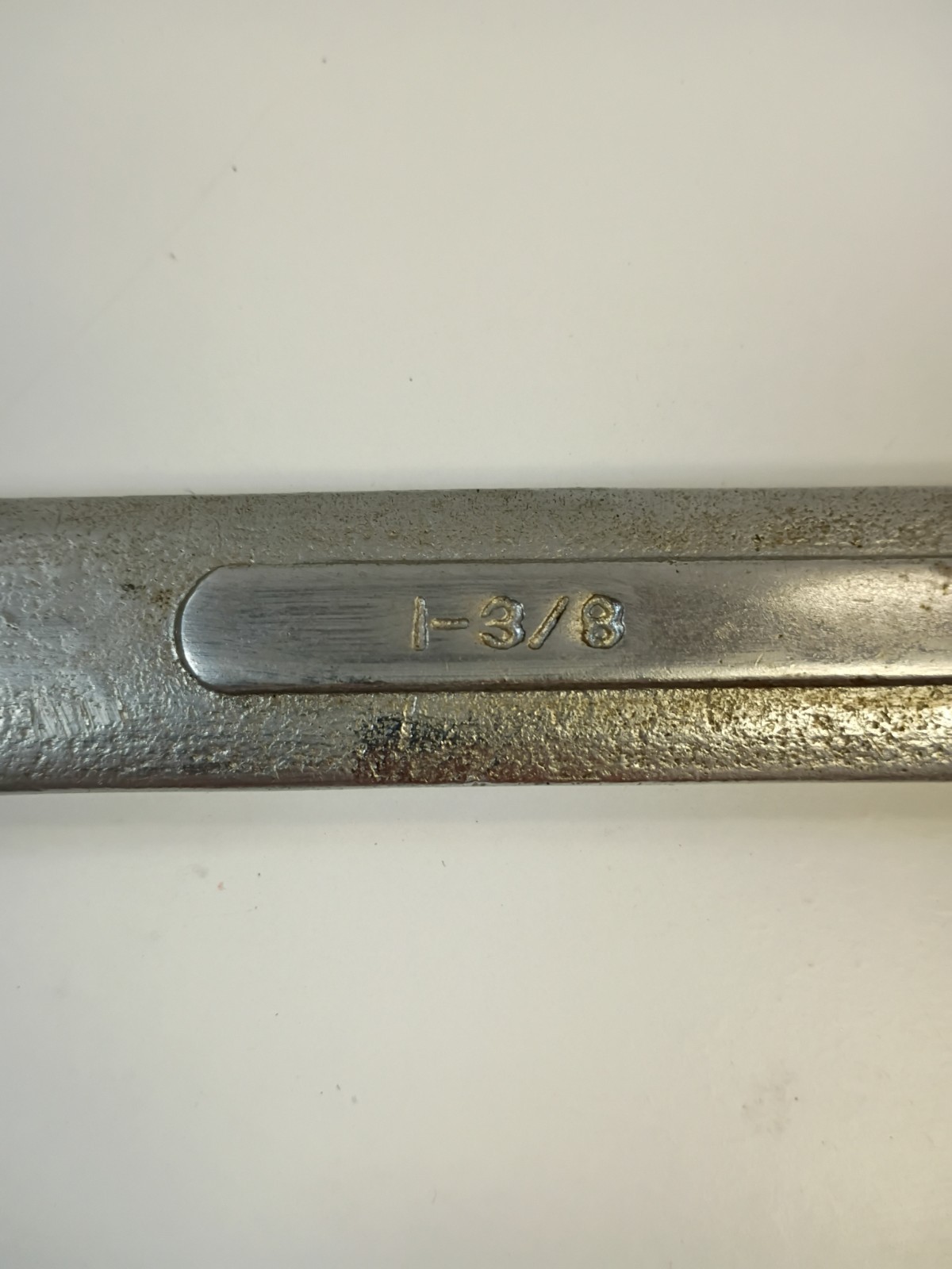 1-3/8-inch combination wrench featuring an open end and a 12-point box end