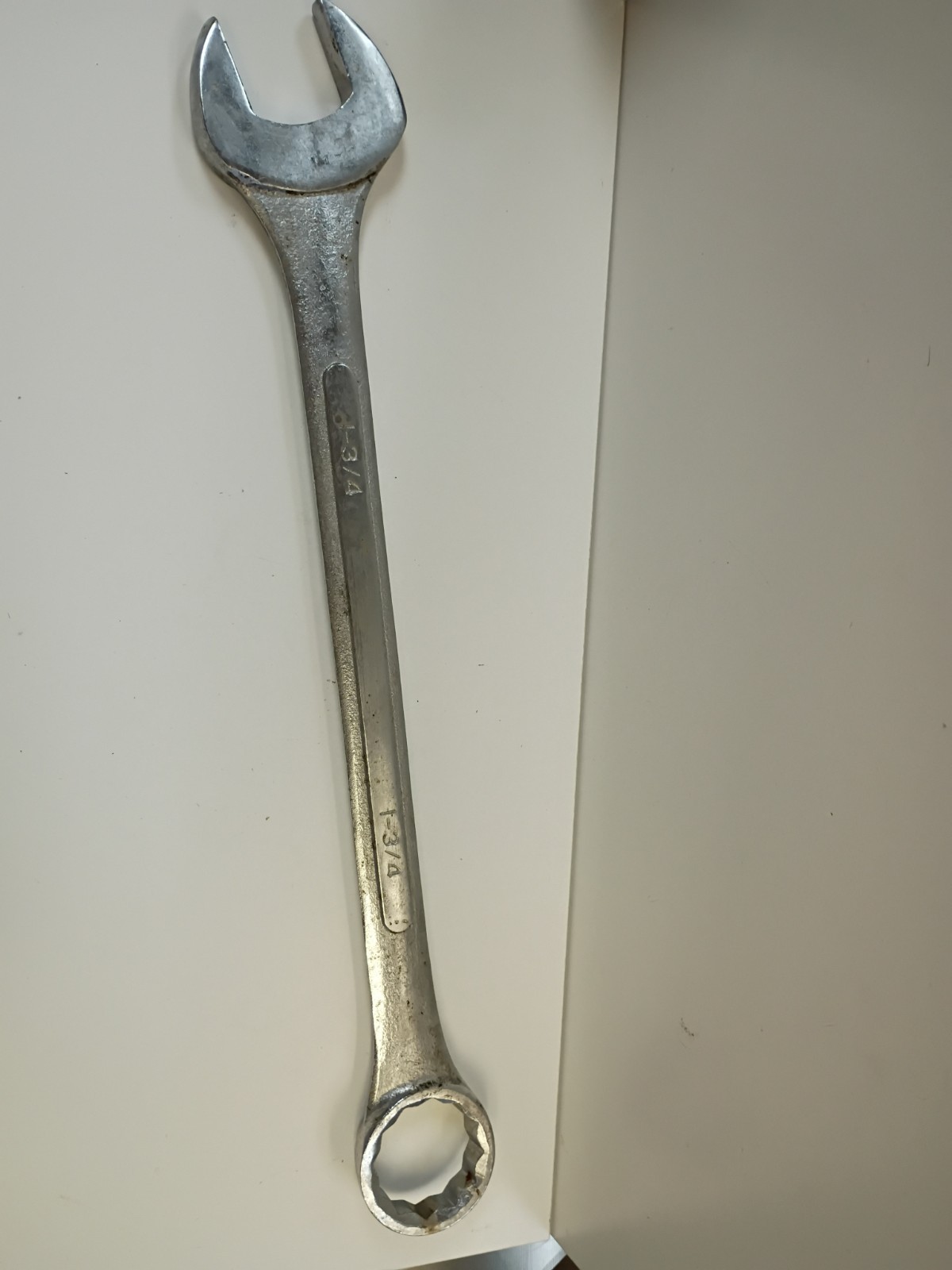 1 3/4-inch combination wrench featuring an open end and a 12-point box end