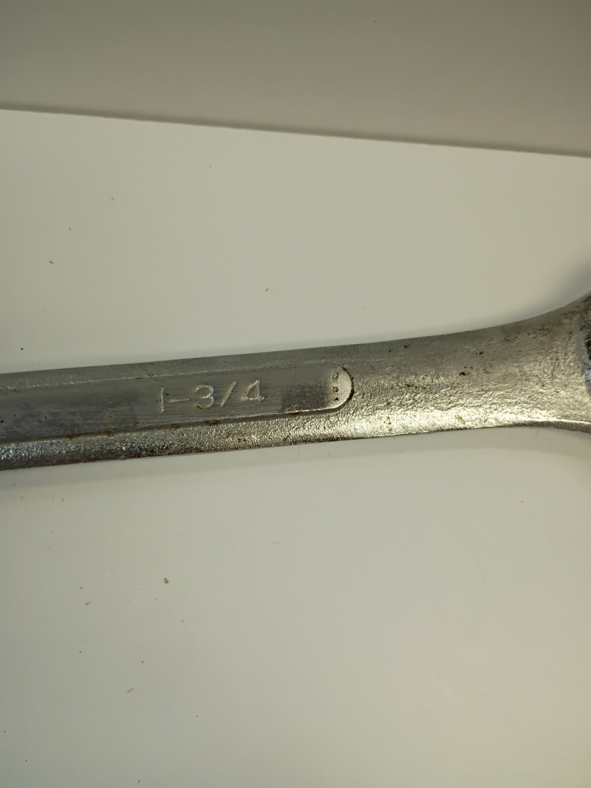 1 3/4-inch combination wrench featuring an open end and a 12-point box end