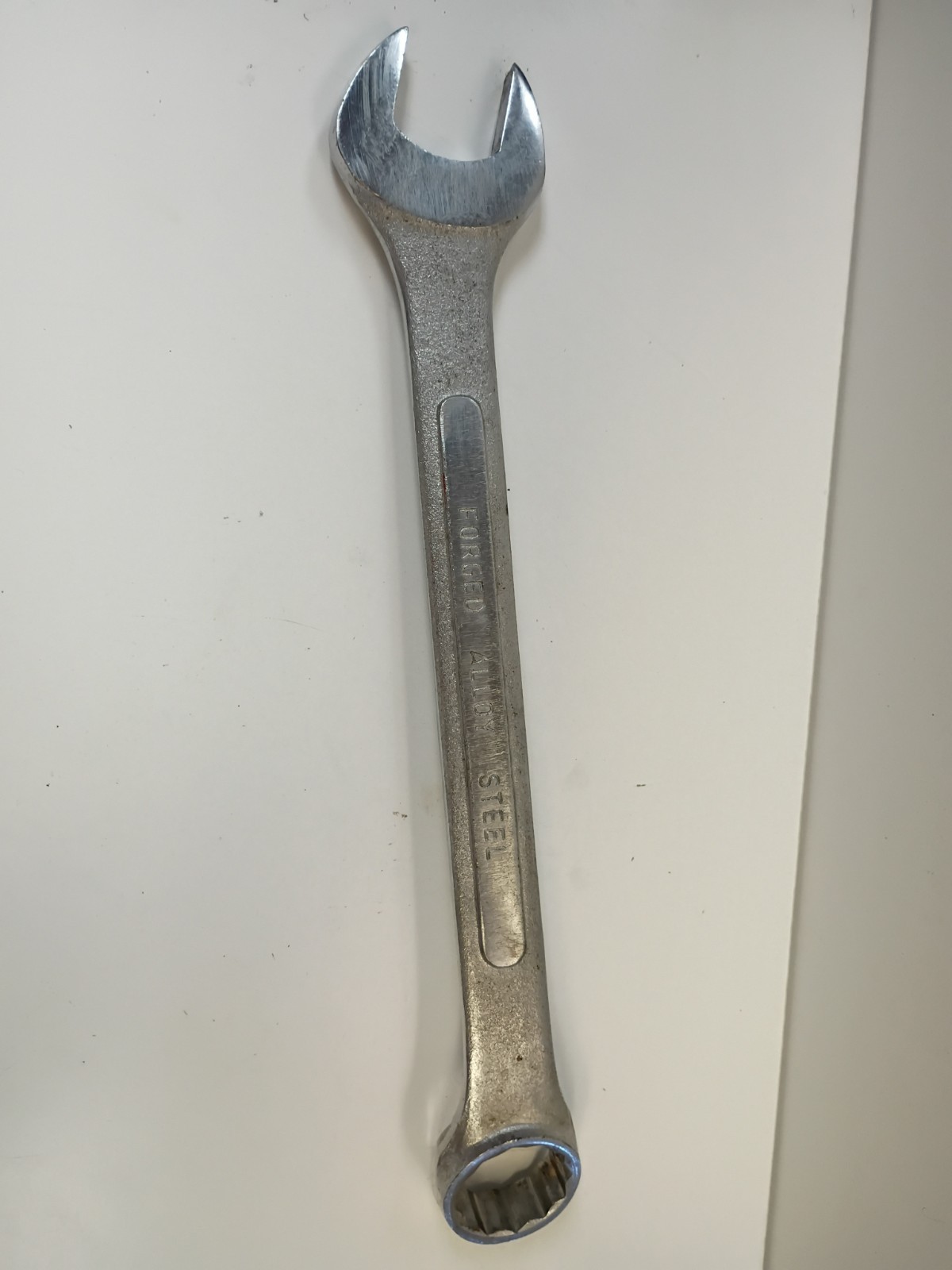 1-1/8-inch combination wrench featuring an open end and a 12-point box end