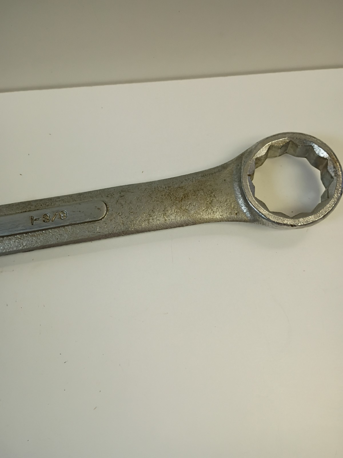 1-3/8-inch combination wrench featuring an open end and a 12-point box end