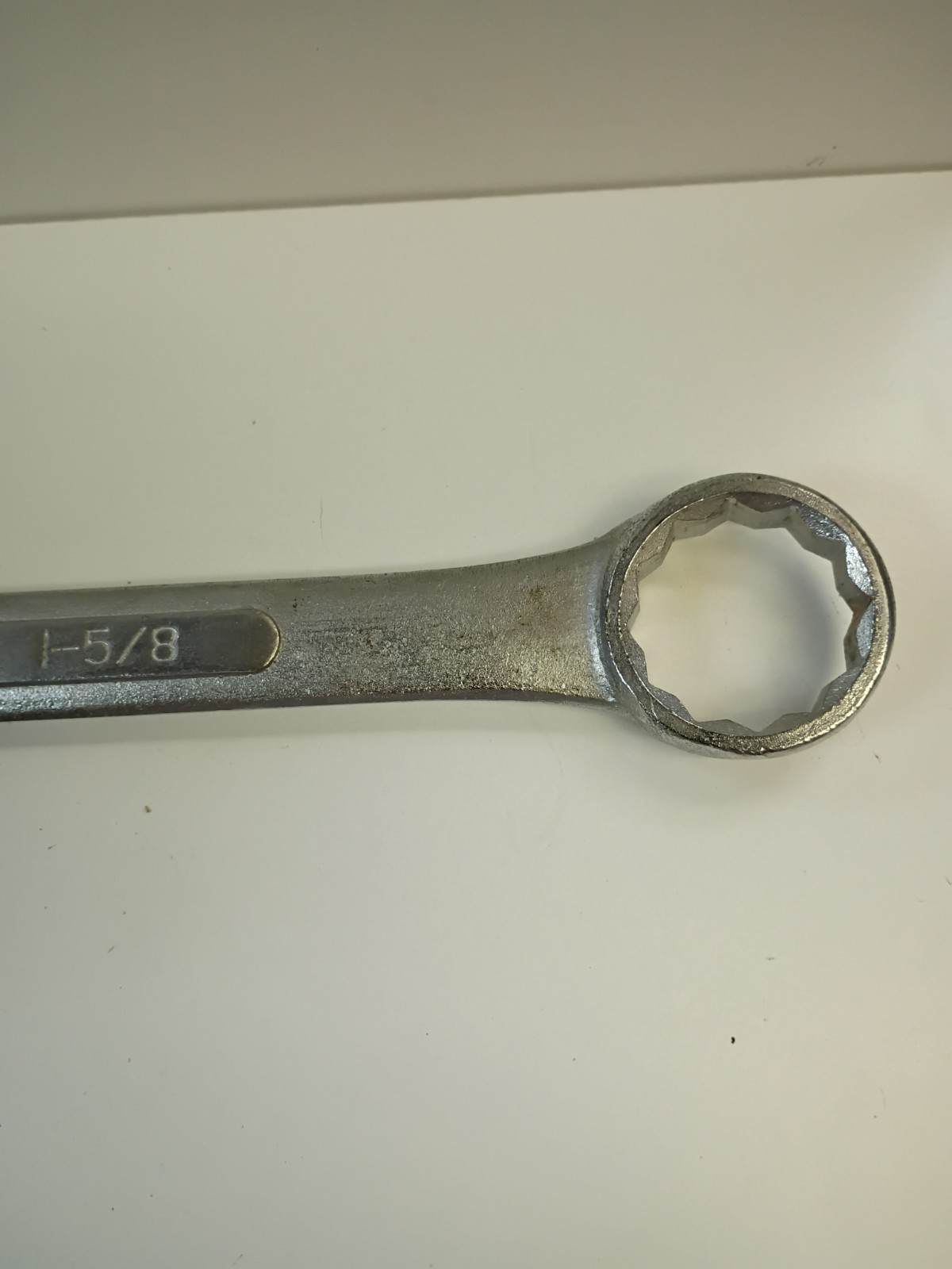 1 5/8-inch combination wrench featuring an open end and a 12-point box end