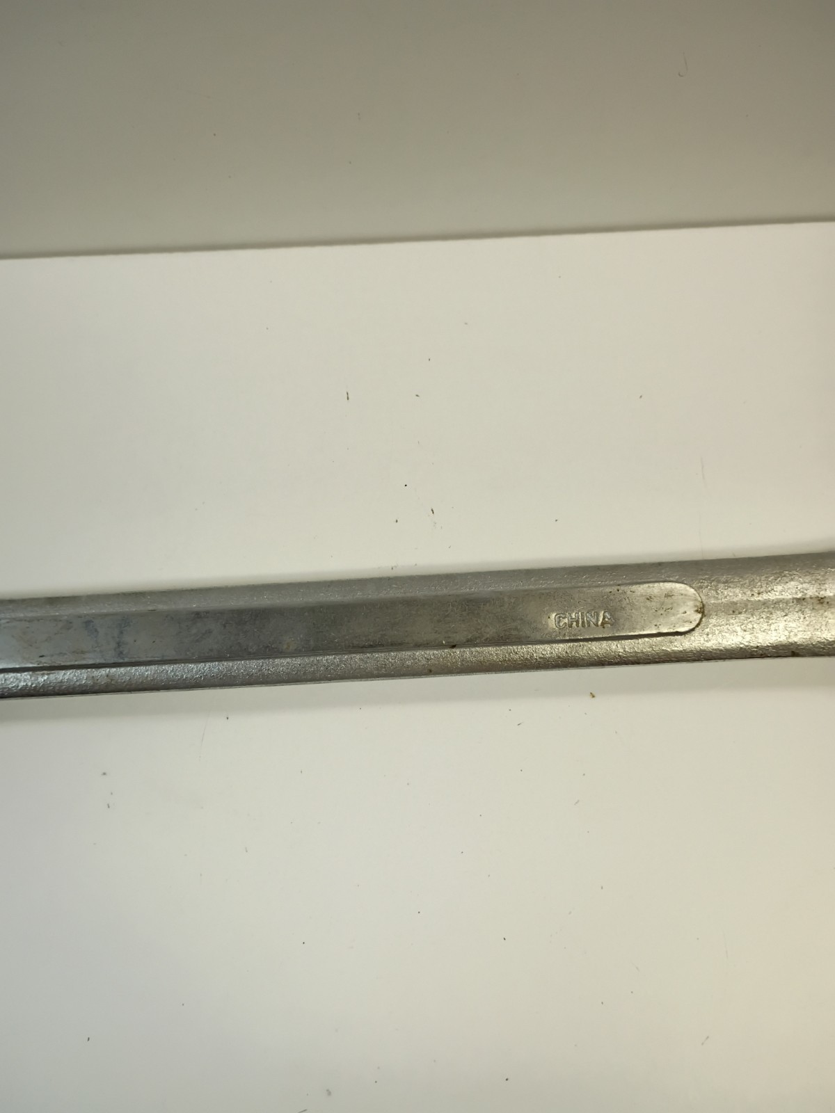 1 5/8-inch combination wrench featuring an open end and a 12-point box end
