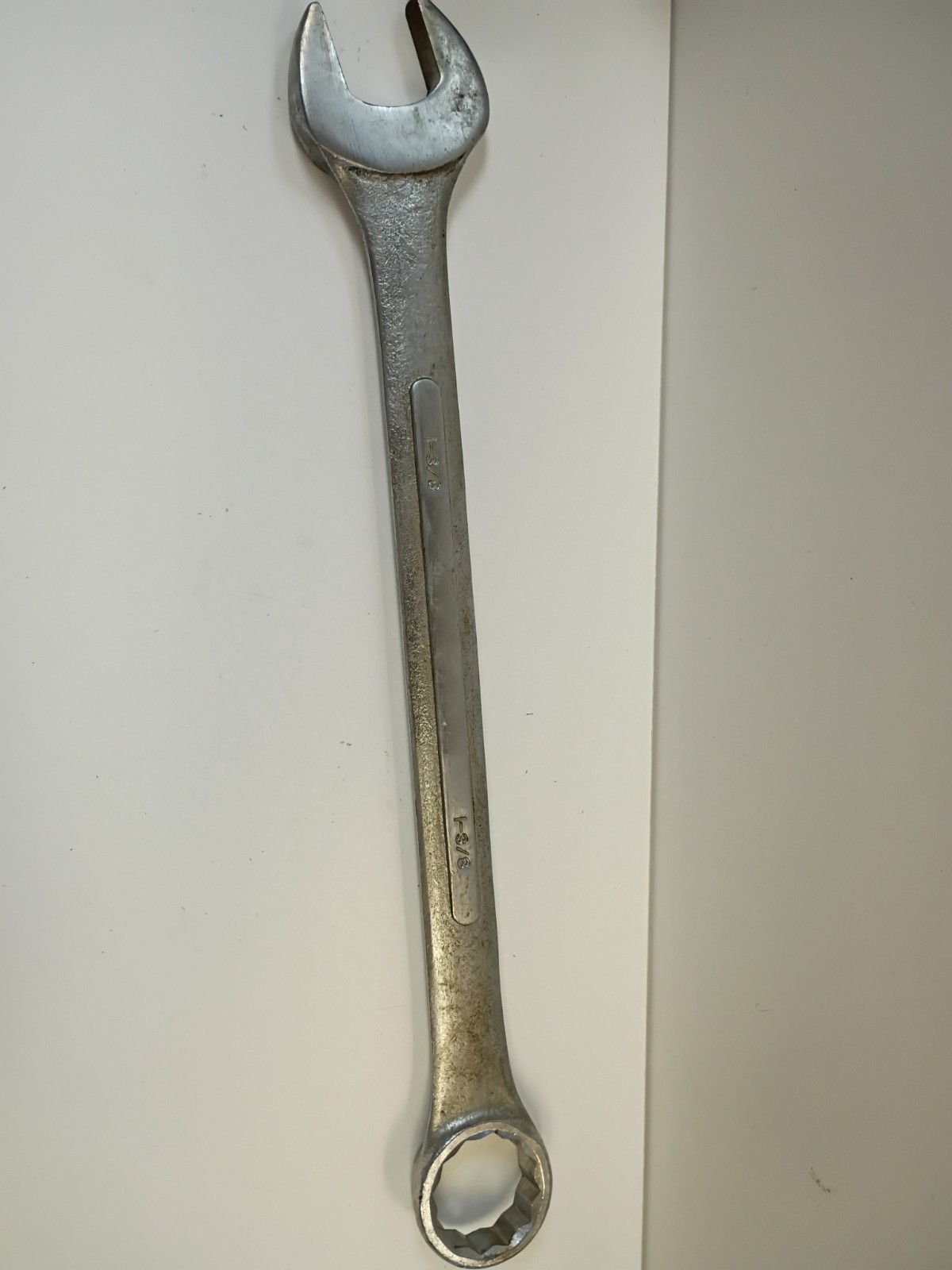 1-3/8-inch combination wrench featuring an open end and a 12-point box end