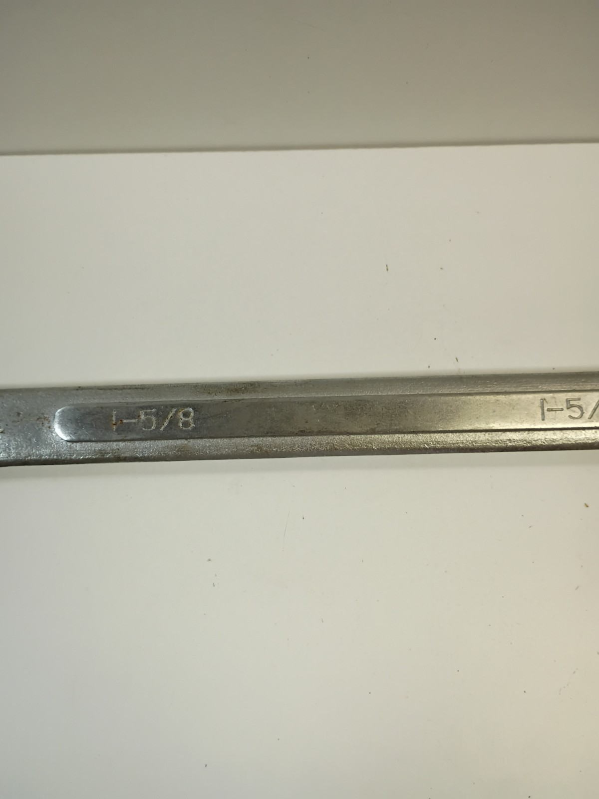 1 5/8-inch combination wrench featuring an open end and a 12-point box end