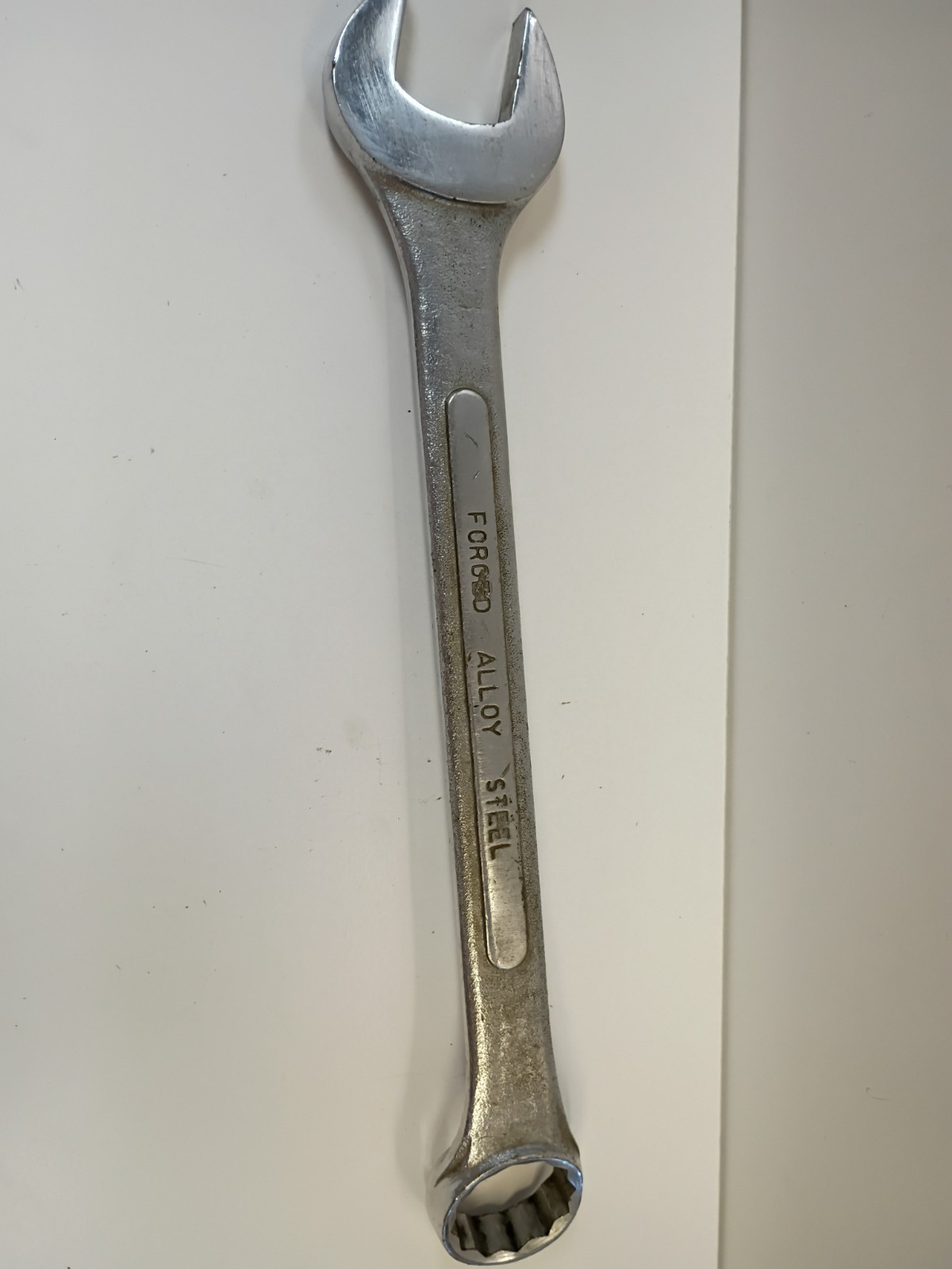1-1/4-inch combination wrench featuring an open end and a 12-point box end
