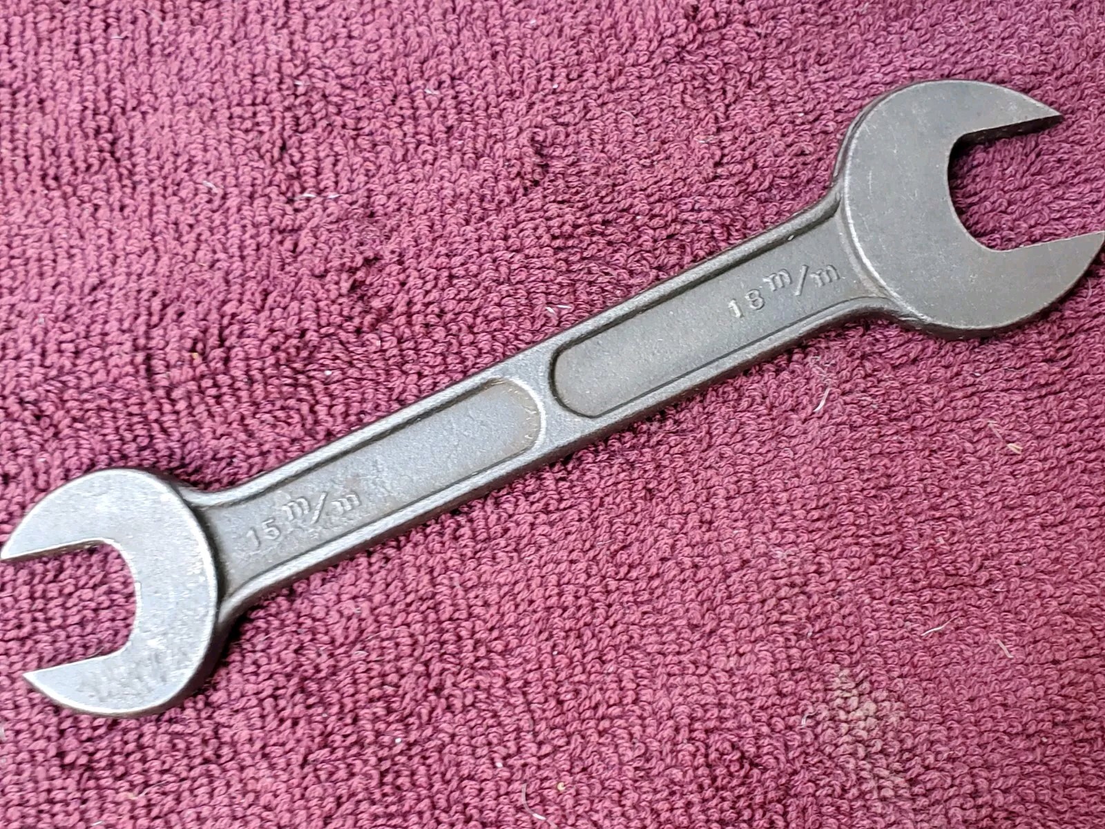 Unmarked 11/16″ by 19/32″ or 15 mm by 18 mm Open End Wrench