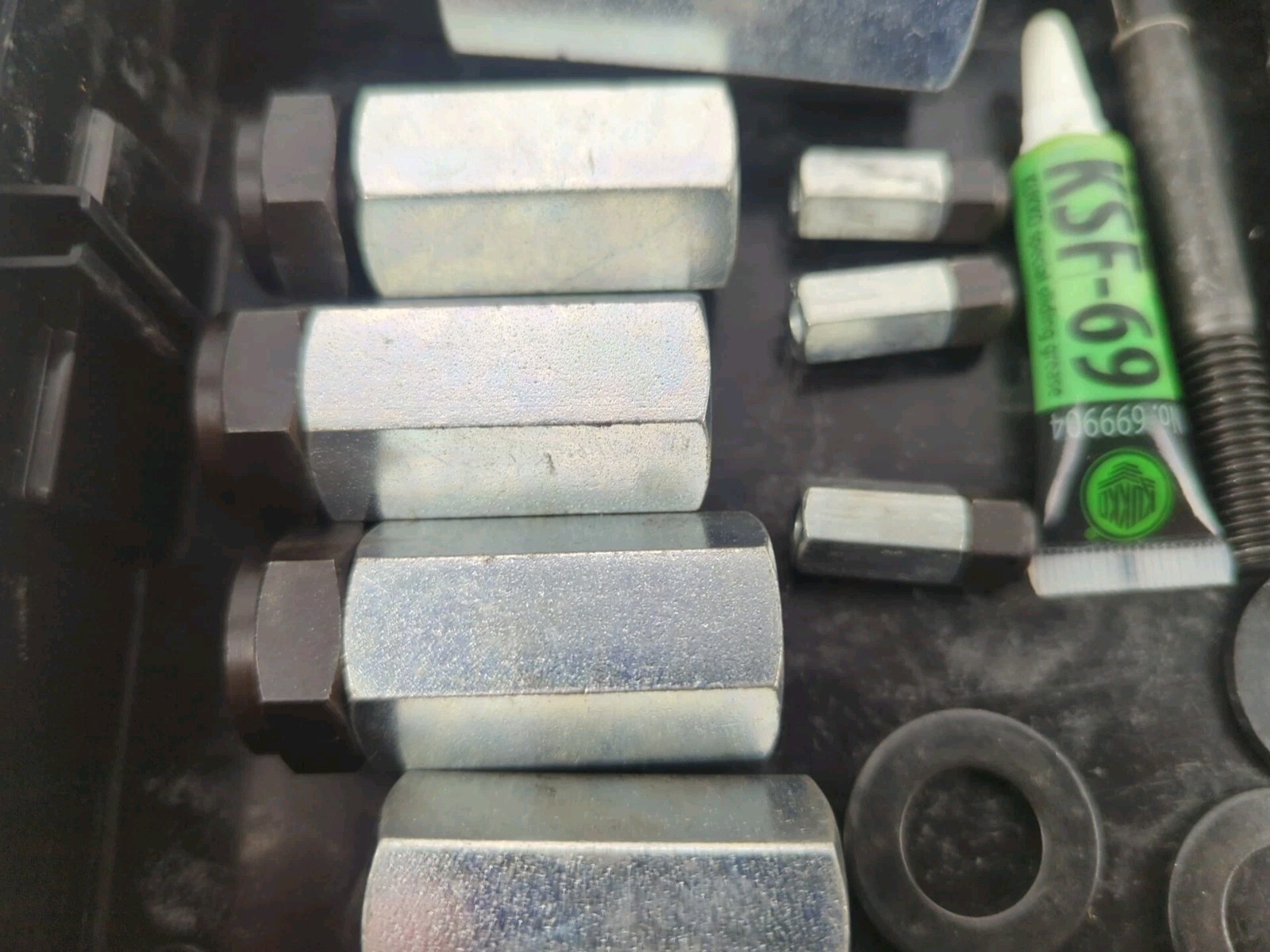 Kukko L Boxx Mini with various connecting nuts adapters bolts washers